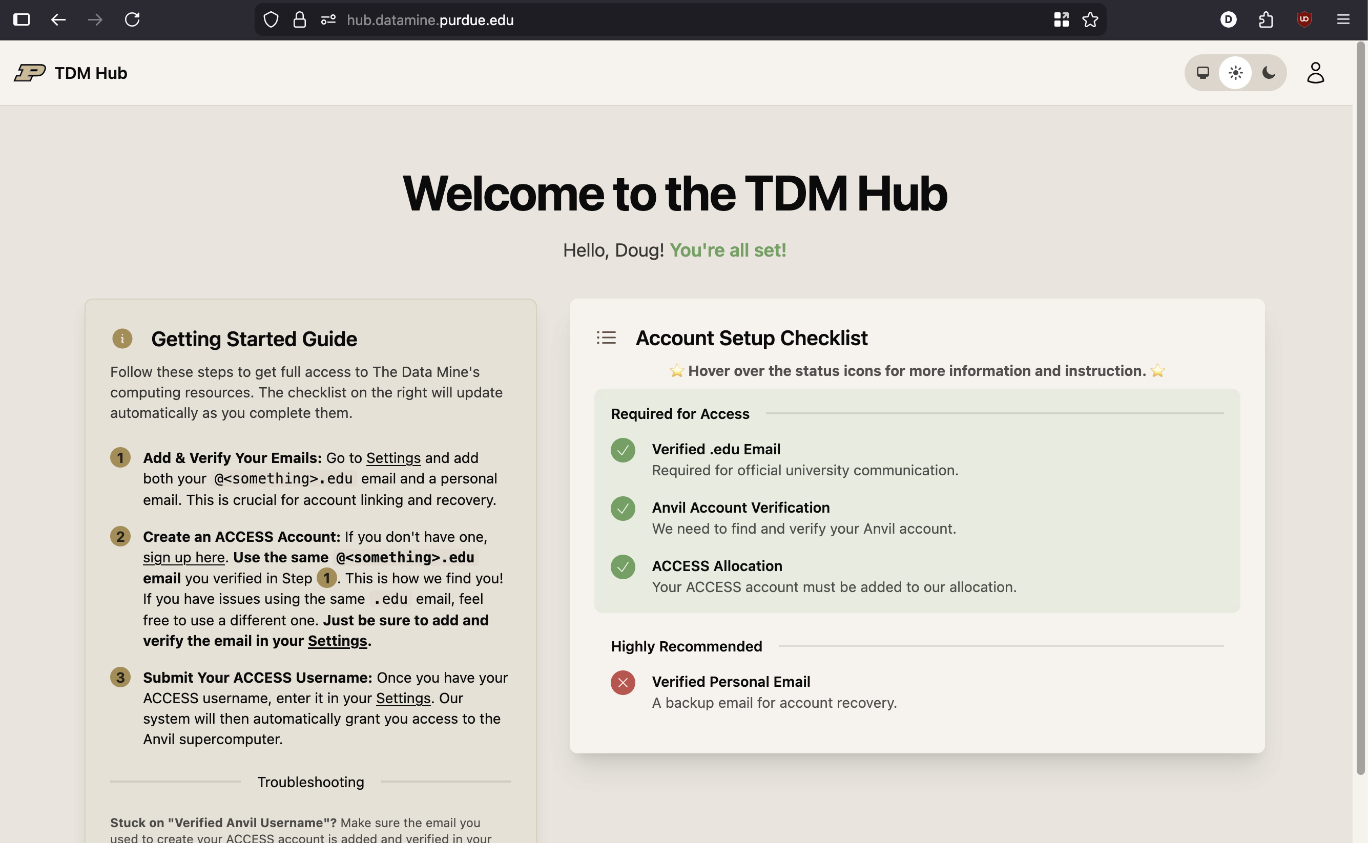 A screenshot of the TDM Hub dashboard. It shows a checklist of items like 'ACCESS Username Provided' and 'Email Verified'. Some items are red (incomplete) and some are green (complete).